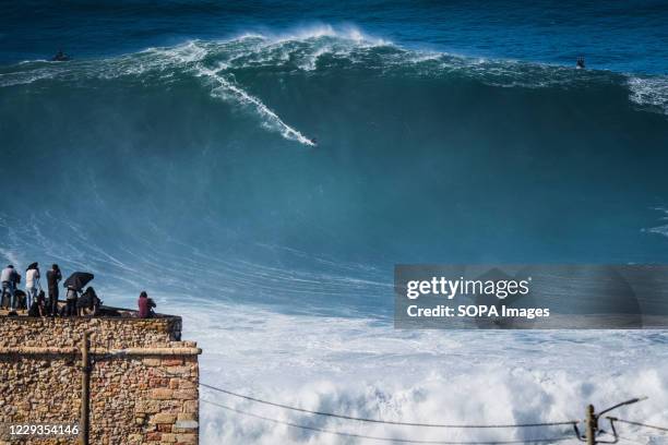 Big wave surfer Sebastian Steudtner from Germany rides a wave during a tow surfing session at Praia do Norte on the first big swell of winter season.