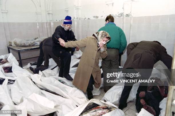 Family walks through the Sarajevo morgue on January 7, 1993 trying to find some of their relatives. - 53 bodies arrived in the morgue January 6 in an...