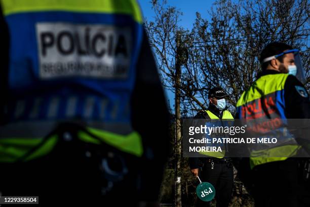 Portuguese police officers man a checkpoint at Vila Franca de Xira in Lisbon on October 30, 2020 as circulation between municipalities became...