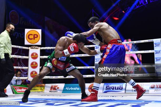 Wanchana Meenayothin of Thailand punches Omar Elquers of Morocco during the WBC Asia Super Featherweight title bout at Rangsit International Boxing...