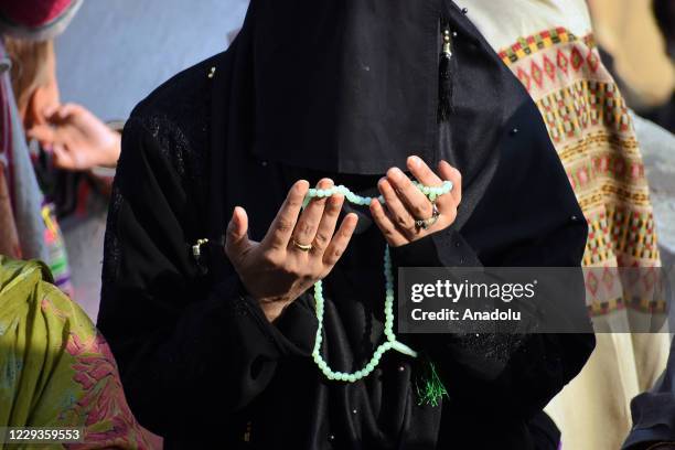 Kashmiri muslim woman prays on the occasion of celebration of Mawlid-un-Nabi or Prophet Muhammad's birth anniversary in Dargah Hazratbal shrine in...