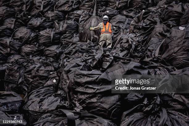 Radioactive soil has been decontaminated from the land around Fukushima and packed in black bags that are stacked on piles while waiting to be...