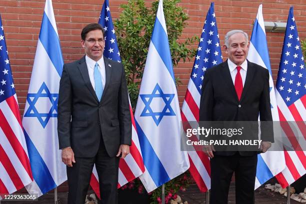 Defense Secretary Mark Esper and Israeli Prime Minister Benjamin Netanyahu pose for a picture together as they meet at the Israel Aerospace...