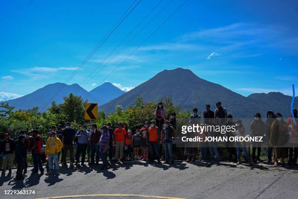 People watch the stage 8 of the Vuelta a Guatemala cycling race in San Pablo La Laguna, 165 km west of Guatemala City, on October 30, 2020. - The LX...