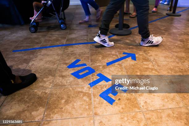 People head to the voting booths to cast their in-person absentee ballots at Seacoast Church West Ashley on October 30, 2020 in Charleston, South...