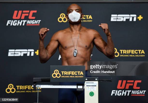 In this handout image provided by UFC, Anderson Silva of Brazil poses on the scale during the UFC Fight Night weigh-in at UFC APEX on October 30,...
