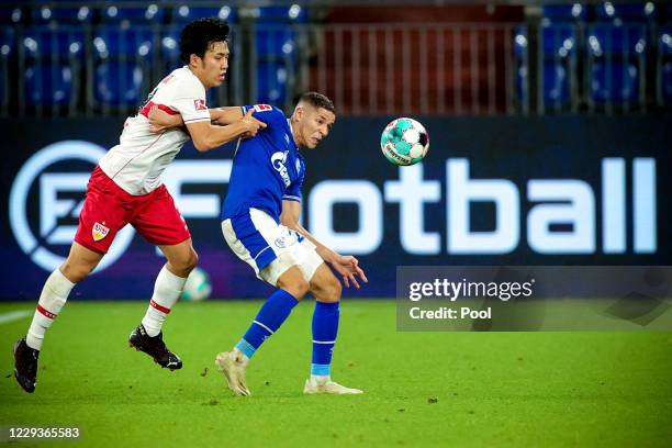 Schalke's Amine Harit in action against Stuttgart's Wataru Endo during the Bundesliga match between FC Schalke 04 and VfB Stuttgart at Veltins-Arena...