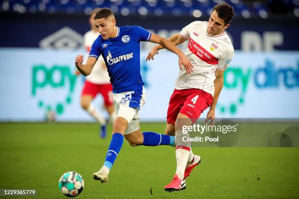 Schalke's Amine Harit in action against Stuttgart's Marc Oliver Kempf during the Bundesliga match between FC Schalke 04 and VfB Stuttgart at...