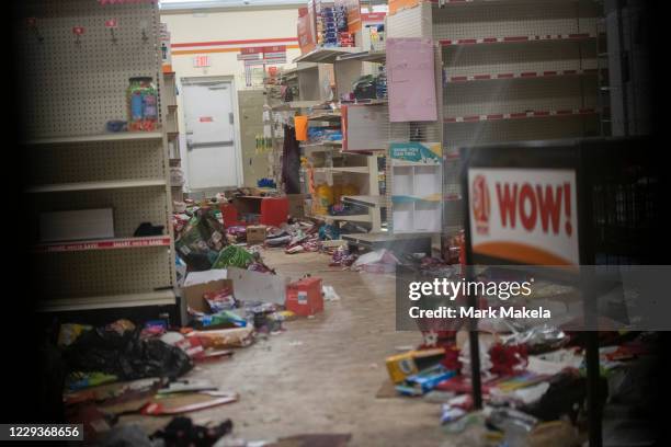 Merchandise lays strewn on the floor after looting as seen through a boarded up door of a discount store on October 30, 2020 in Philadelphia,...