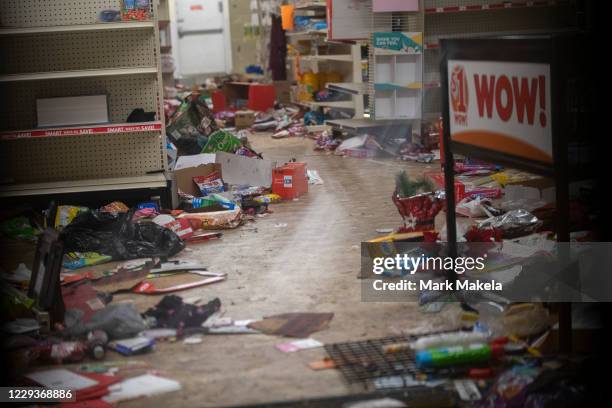 Merchandise lays strewn on the floor after looting as seen through a boarded up door of a discount store on October 30, 2020 in Philadelphia,...