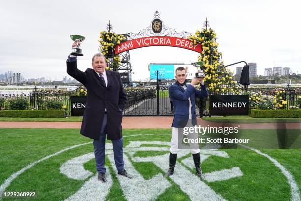 Trainer of Johnny Get Angry , Denis Pagan and Lachlan King pose with the trophy after winning the AAMI Victoria Derby at Flemington Racecourse on...