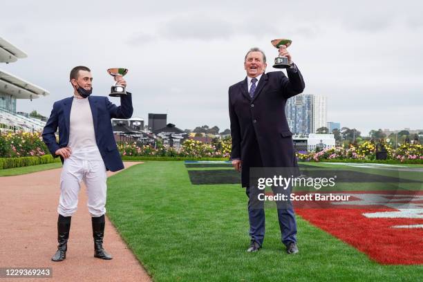 Trainer of Johnny Get Angry , Denis Pagan and Lachlan King pose with the trophy after winning the AAMI Victoria Derby at Flemington Racecourse on...