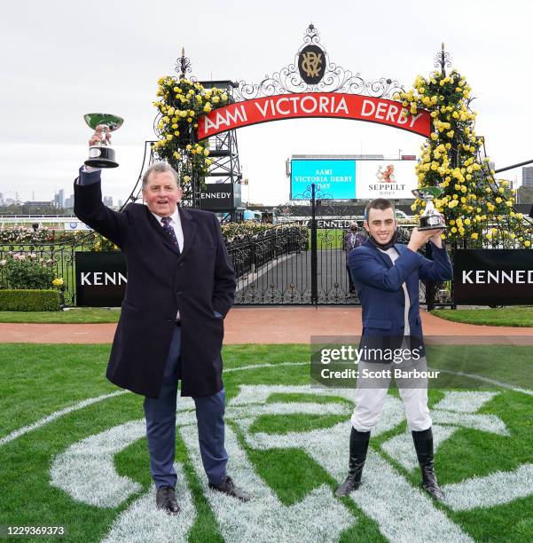 Trainer of Johnny Get Angry , Denis Pagan and Lachlan King pose with the trophy after winning the AAMI Victoria Derby at Flemington Racecourse on...