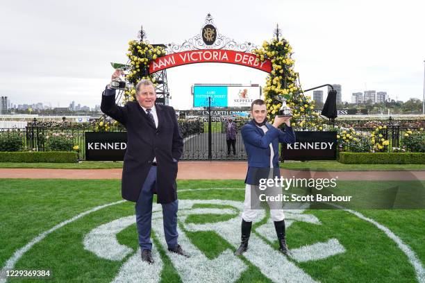 Trainer of Johnny Get Angry , Denis Pagan and Lachlan King pose with the trophy after winning the AAMI Victoria Derby at Flemington Racecourse on...