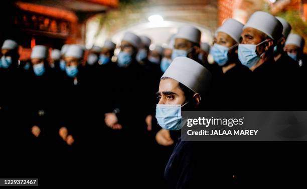 Members of the Druze community attend the funeral of late spiritual leader Hassan Halabi, who died at the age of 75 of complications of COVID-19...