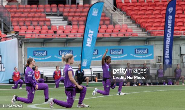 Hurricanes players take a knee at the start of the Women's Big Bash League WBBL match between the Brisbane Heat and the Hobart Hurricanes at GIANTS...