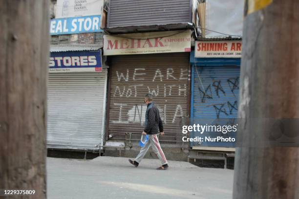 Kashmiri man walks before closed shops during shutdown in Srinagar, Indian Adminsitered Kashmir on 31 October 2020. Shutdown call was given by pro...