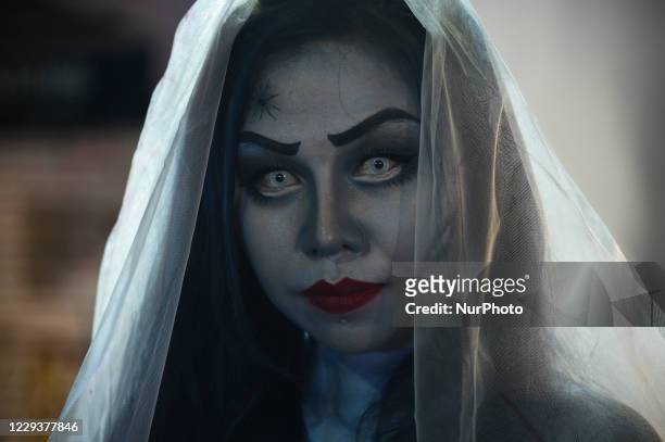 Thai people wearing costume Halloween stand along a street during Halloween celebrations at Khao San Road, a popular tourist destination, in Bangkok,...