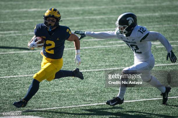 Chris Jackson of the Michigan State Spartans misses a tackle against Blake Corum of the Michigan Wolverines, which resulted in a touchdown, during...