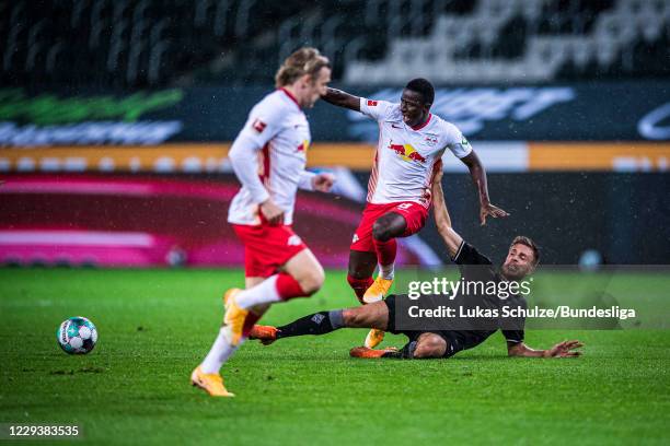 Amadou Haidara of Leipzig and Patrick Herrmann of Mönchengladbach in action during the Bundesliga match between Borussia Mönchengladbach and RB...