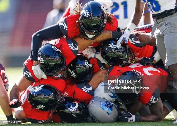 Javon Ivory of the Memphis Tigers is tackled by seven members of the Cincinnati Bearcats defense during the first half at Nippert Stadium on October...