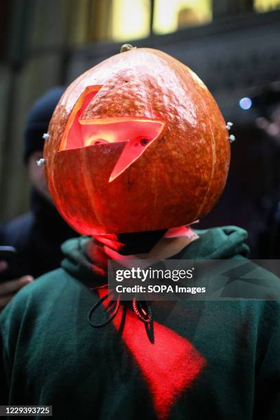 Protester wearing a Halloween-like pumpkin mask with cut-out lightning pattern, symbolising Women's Strike during the demonstration. The Polish...