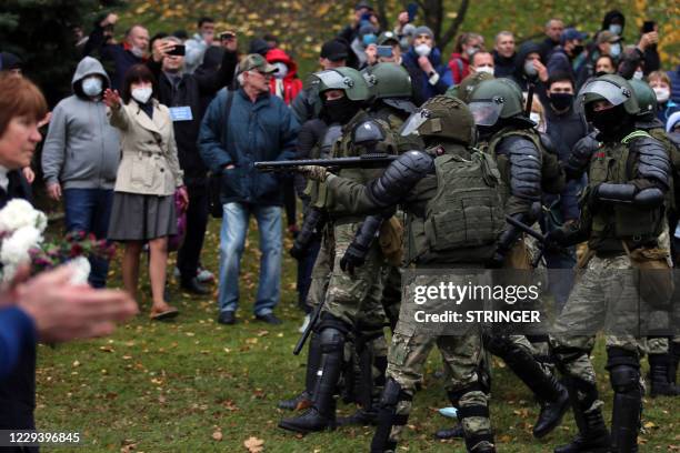 Law enforcement officers block protesters during a march of opposition supporters from central Minsk to a site of Stalin-era executions just outside...