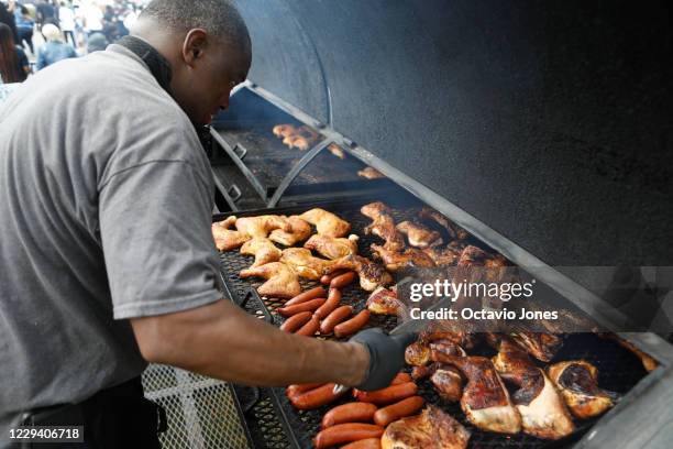 Michael Pettway grills chicken and hotdogs during the NAACP Hillsborough County Branch Souls to the Polls voter drive at the C. Blythe Andrews, Jr....