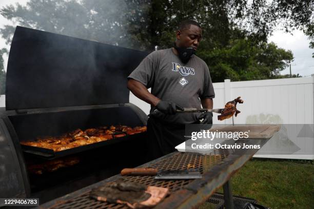 Michael Pettway grills chicken and hotdogs during the NAACP Hillsborough County Branch Souls to the Polls voter drive at the C. Blythe Andrews, Jr....