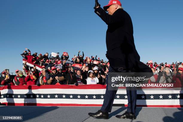 President Donald Trump leaves after speaking during a Make America Great Again rally at Dubuque Regional Airport on November 1 in Dubuque, Iowa. -...