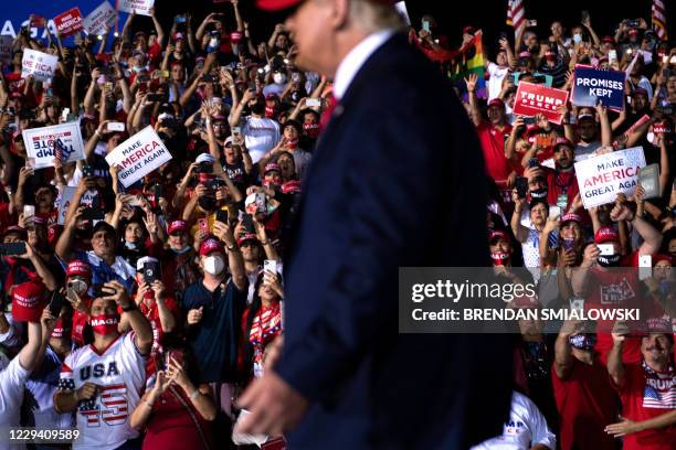 People cheer for US President Donald Trump during a Make America Great Again rally at Miami-Opa Locka Executive Airport in Opa Locka, Florida on...