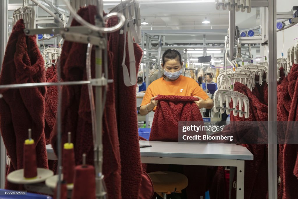 An employee works on a garment production line at Alibaba Group... News ...