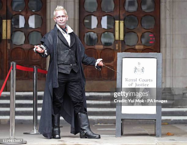 Matty, a Johnny Depp supporter dressed as the character Grindelwald from the film Fantastic Beasts, outside the High Court in London, where Mr...