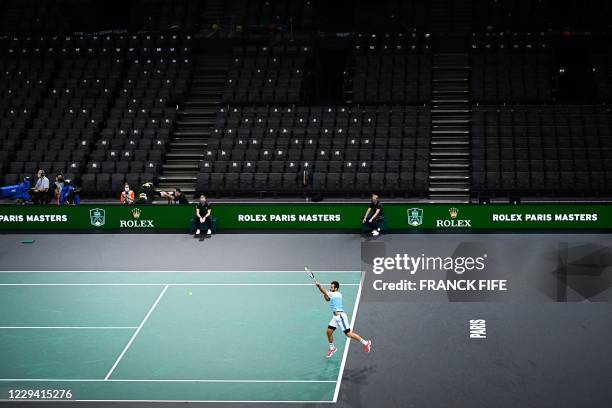 Italy's Salvatore Caruso returns the ball to France's Corentin Moutet during their men's singles first round tennis match on day 1 at the ATP World...