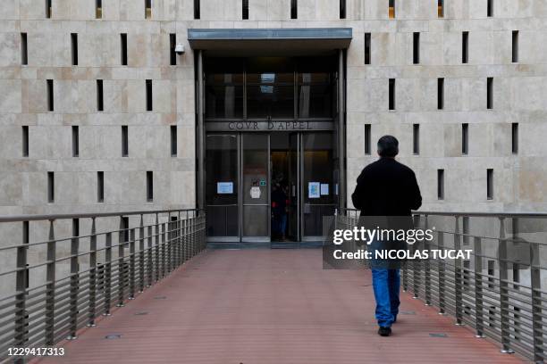 Man walks to enter the appeal court in Aix-en-Provence, on November 2 on the opening day of the appeal trial of the Pastor murder case.