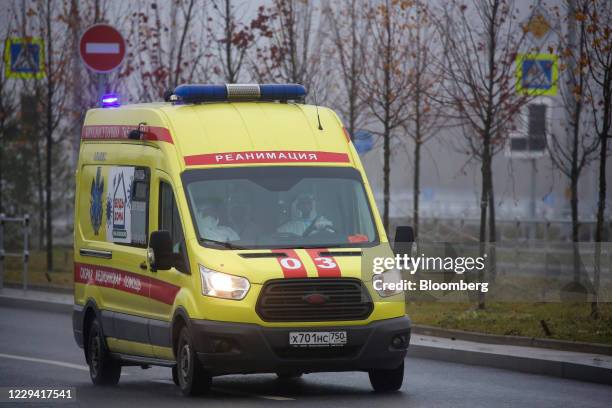 Medical workers drive an ambulance into the Novomoskovsky multi-specialty hospital complex, used to treat coronavirus patients, in the Kommunarka...