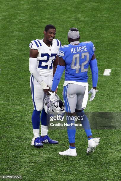 Indianapolis Colts cornerback Xavier Rhodes and Detroit Lions Jaryron Kearse greet each other at the conclusion of an NFL football game against the...
