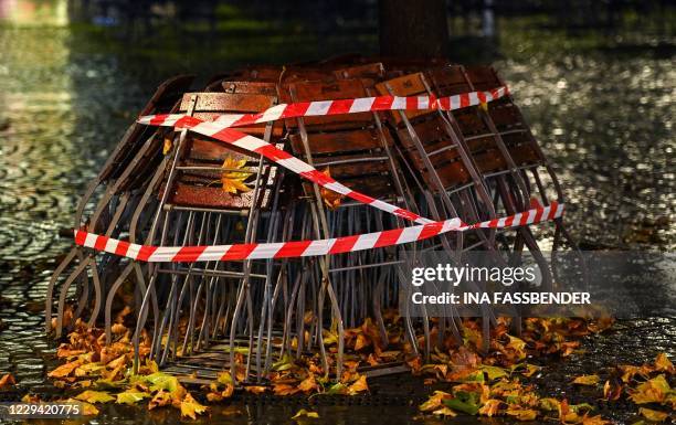 Tables and chairs are locked outside a closed restaurant in Cologne's old town on November 2, 2020 amid the novel coronavirus pandemic. - To curb the...