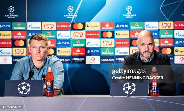 Ajax Amsterdam's head coach Erik Ten Hag and Dutch defender Perr Schuurs address a press conference at the MCH Arena stadium in Herning, Denmark on...
