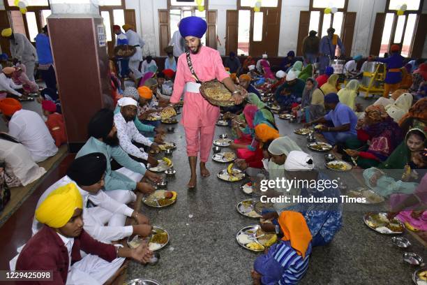 Devotees seated while langar meals are served at the Golden Temple on the occasion of birth anniversary of the fourth Sikh Guru Ramdas on November 2,...