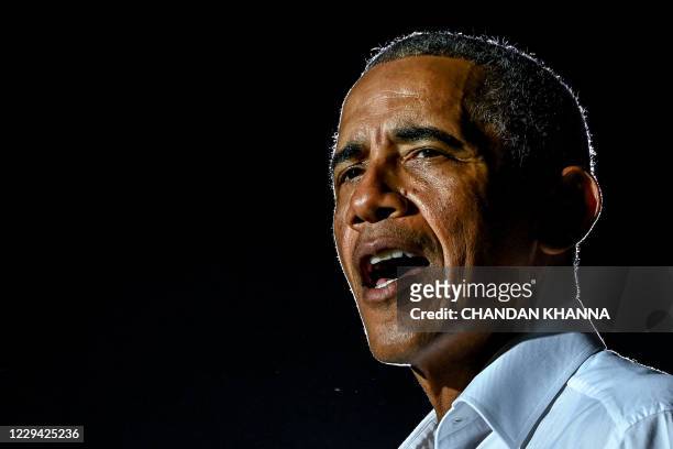 Former US President Barack Obama speaks at a drive-in rally as he campaigns for Democratic presidential candidate former Vice President Joe Biden in...