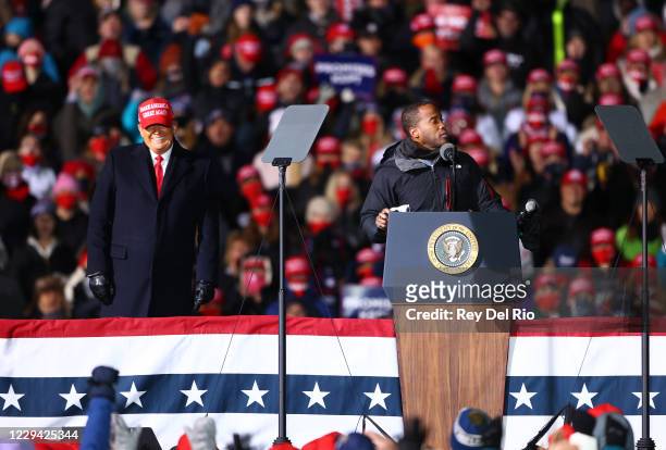 President Donald Trump listen to John James, a Republican U.S. Senate candidate during a campaign rally on November 2, 2020 in Traverse City,...