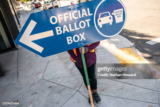 An election worker directs voters to a ballot drop off location on November 2, 2020 in Portland, Oregon. Oregons voting system allows for ballot...