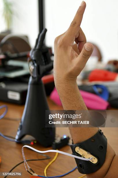 Tunisian engineers test a prototype of an artificial hand on October 20, 2020 at Cure Bionics startup in Sousse. - The startup created by a young...