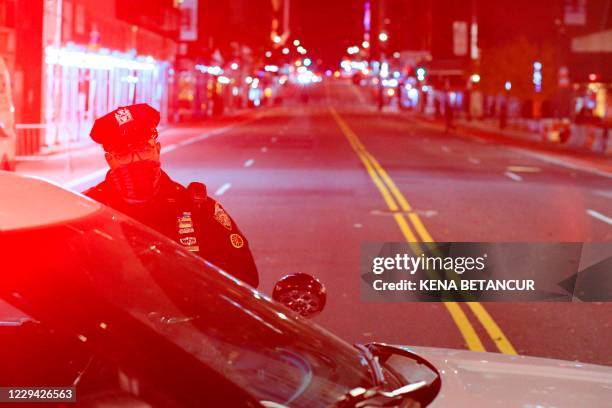 Officer stand guard at the closed 57th street at 5th Avenue the night before the Presidential Elections in New York, November 2, 2020.