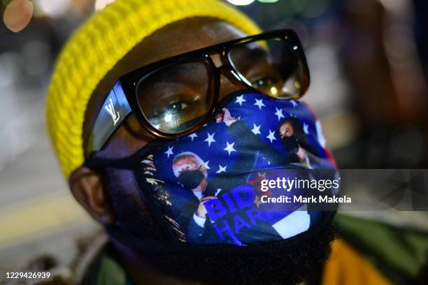 Simon Carr wears a themed face mask at a drive-in election eve rally with Democratic vice presidential nominee Sen. Kamala Harris on November 2, 2020...