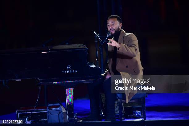 Singer John Legend performs before Democratic vice presidential nominee Sen. Kamala Harris speaks at a drive-in election eve rally on November 2,...