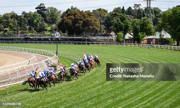 The field passes the winning post for the first time in the Lexus Melbourne Cup at Flemington Racecourse on November 03, 2020 in Flemington,...