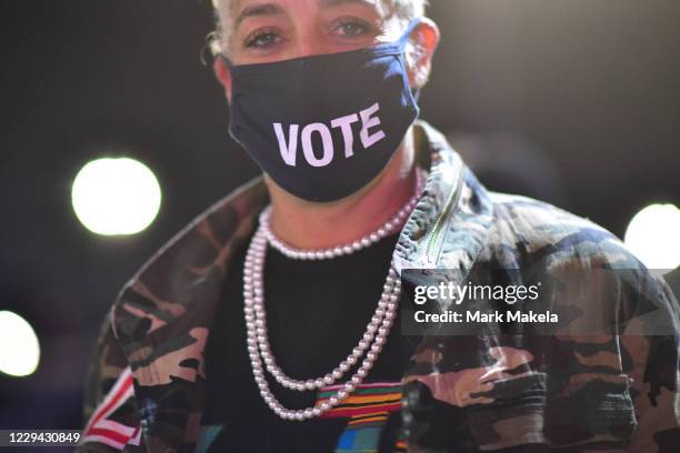 Kristen Hart wears a "VOTE" mask before Democratic vice presidential nominee Sen. Kamala Harris speaks at a drive-in election eve rally on November...