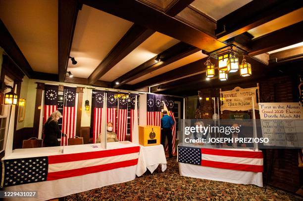 Voters fill out their ballots at the Hale House at the historic Balsams Resort during midnight voting as part of the first ballots cast in the United...